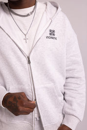White hoodie with 'INCARNIE' logo worn by a person, on a plain background