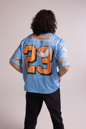 Person wearing a blue jersey with 'Psalm 23' printed on the back against a plain background