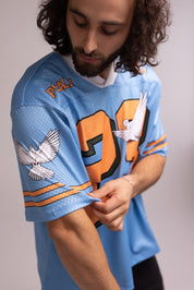 Person wearing a blue sports jersey with orange and white accents