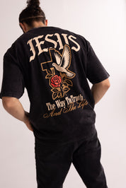 Person wearing a black t-shirt with religious text and symbols on the back.