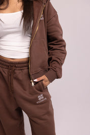 Brown tracksuit with brand logo on a plain background