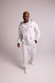 Person wearing a grey tracksuit on a plain background