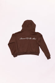 Brown hoodie with text on the back against a white background