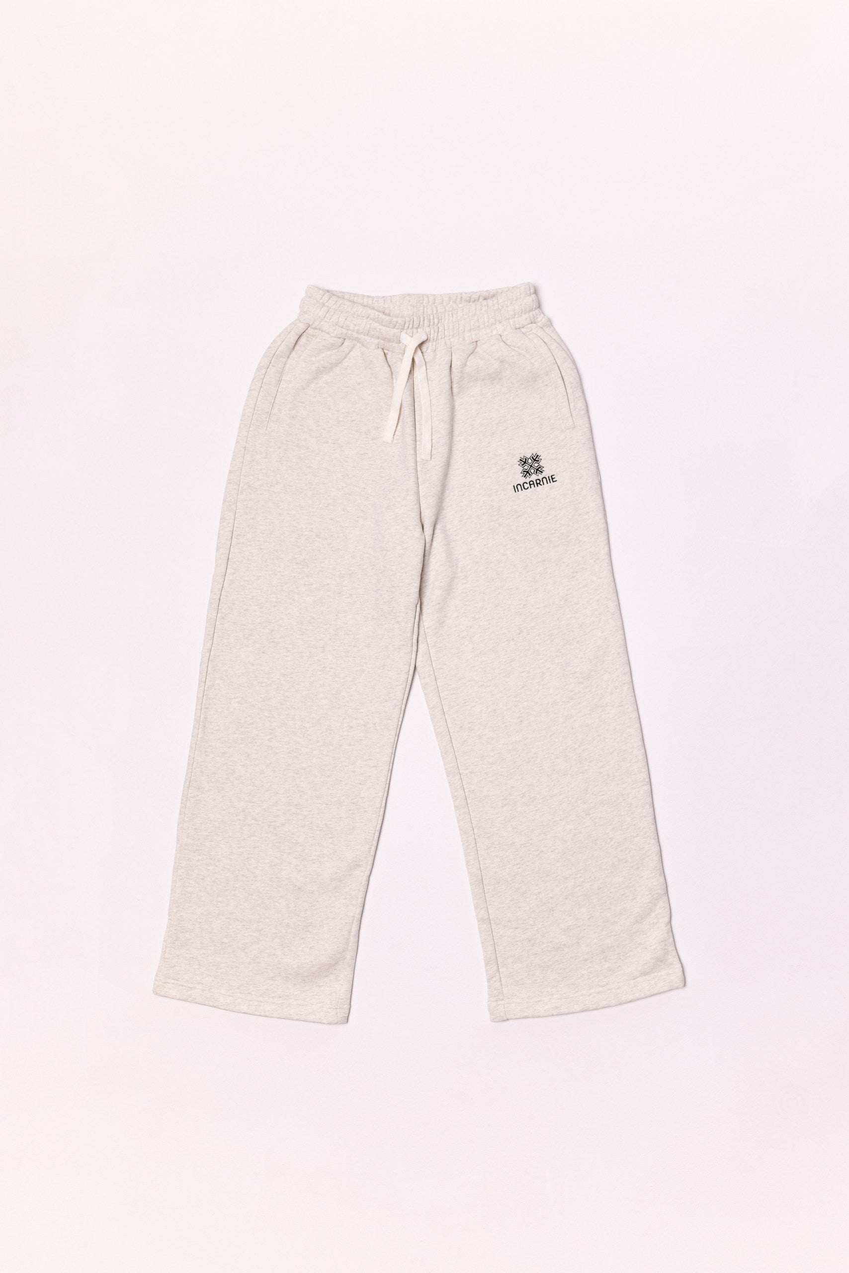 Beige sweatpants with a logo on a light background