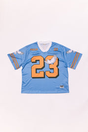 Light blue sports jersey with orange number 23 on a white background