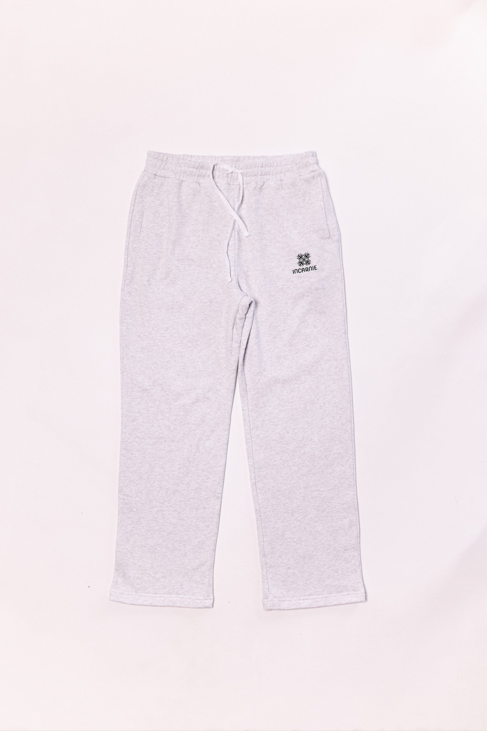 White sweatpants with a logo on a white background