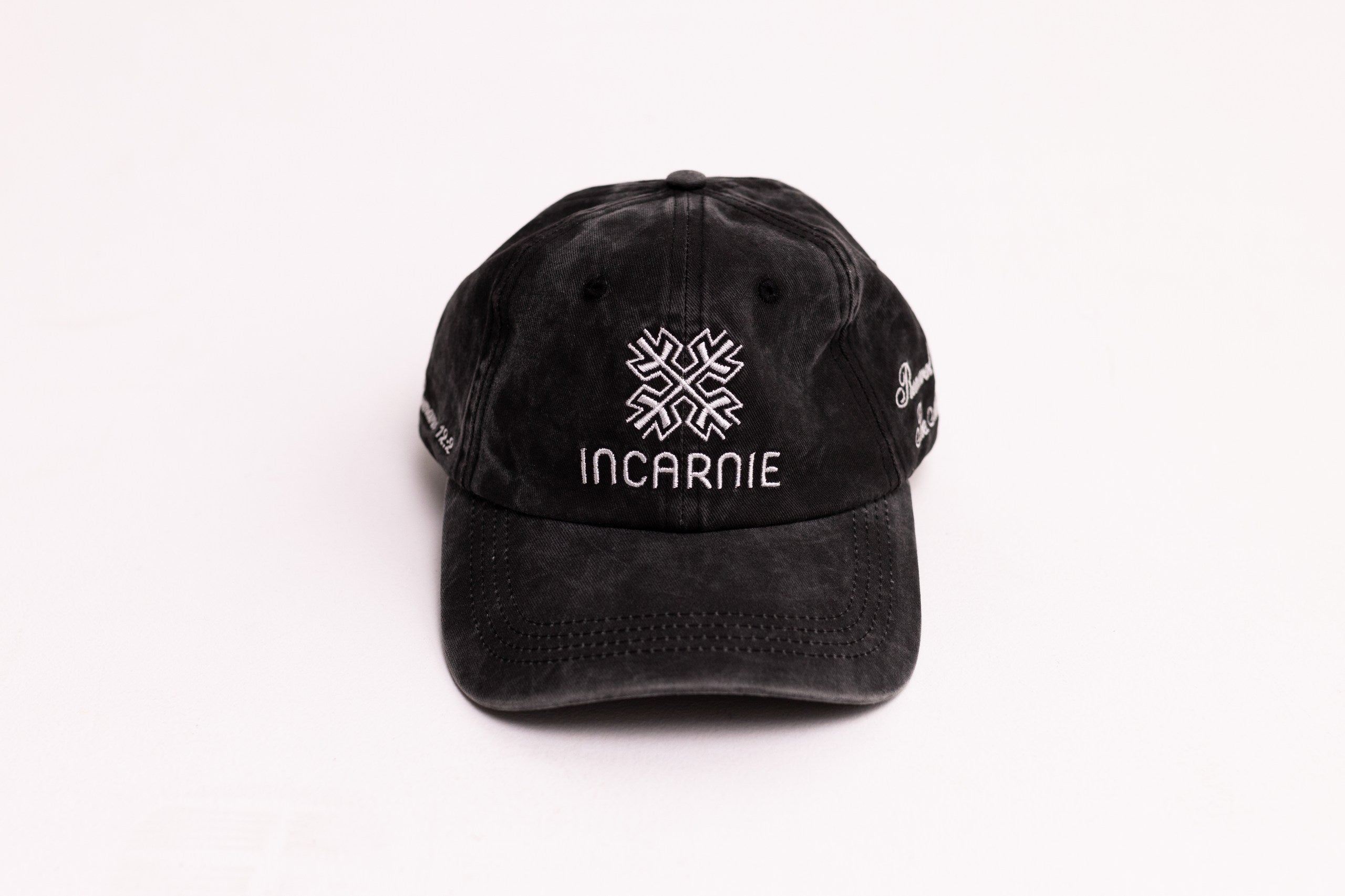 Black cap with Incarnie logo on a white background
