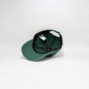 Green cap with black strap on a white background