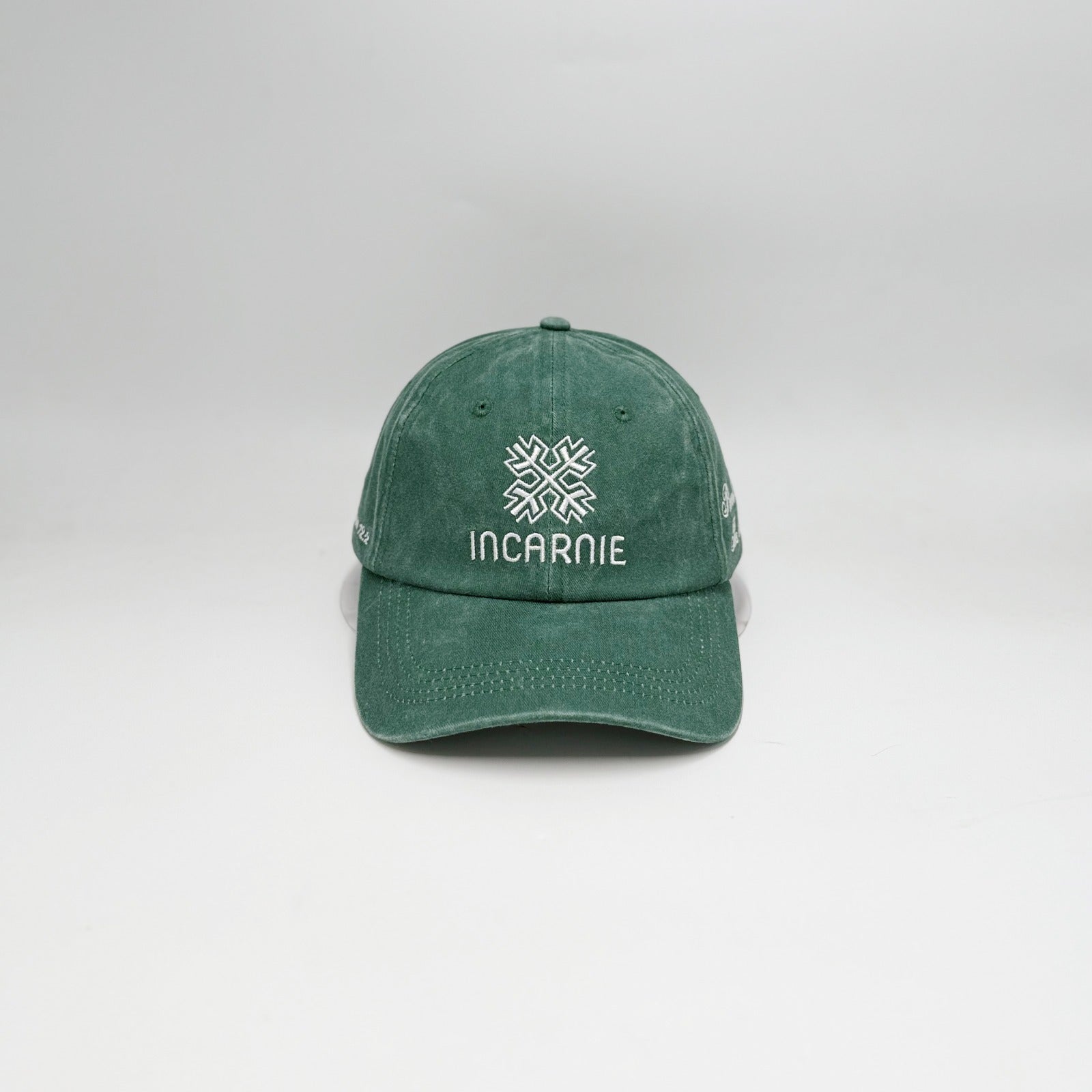 Green cap with Incarnie logo on a white background