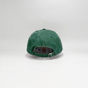 Green baseball cap on a clear stand against a white background